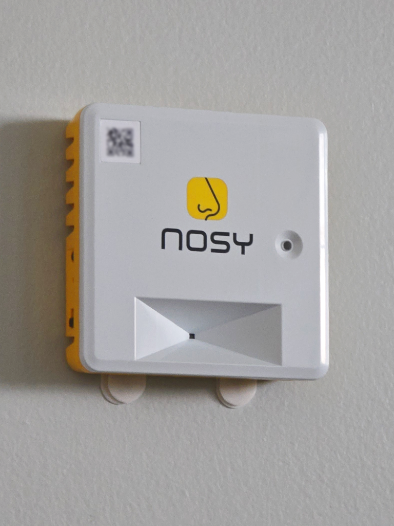 A Nosy building sensor mounted on a wall