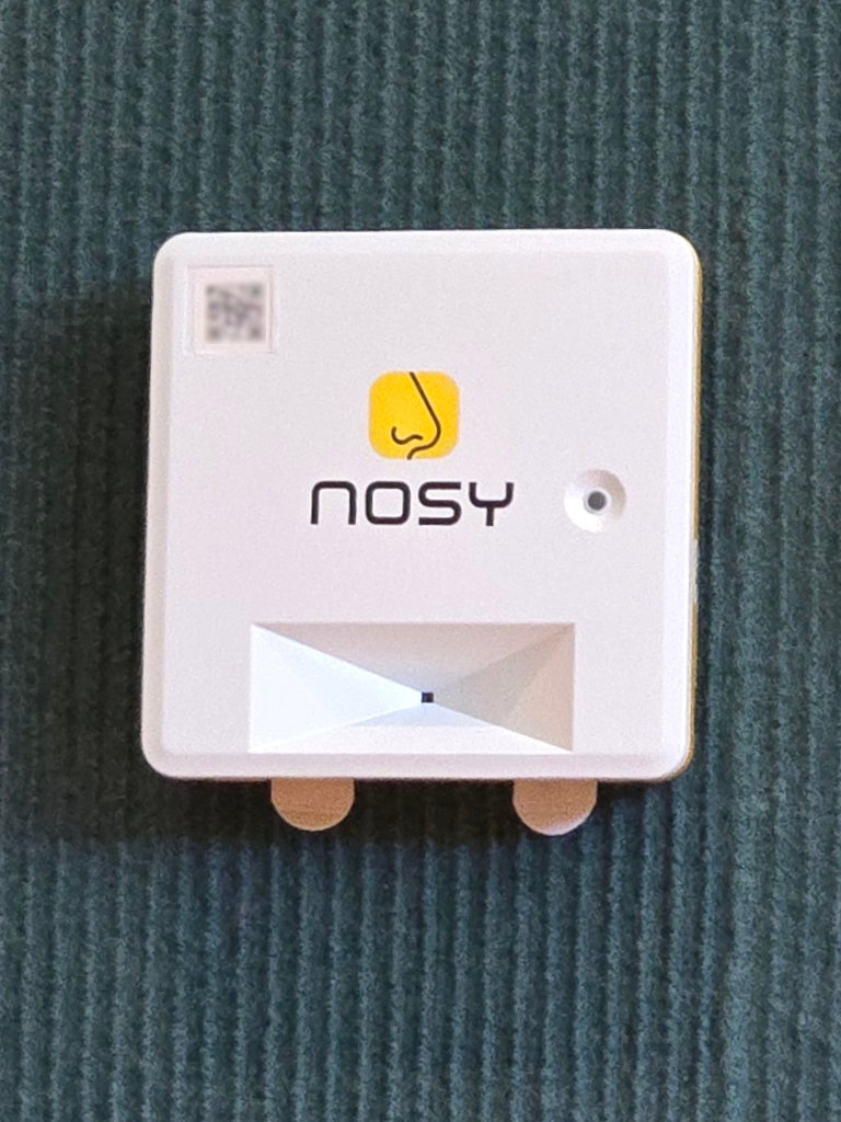 A Nosy building sensor mounted on a wall
